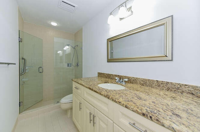 bathroom featuring an enclosed shower, vanity, and toilet