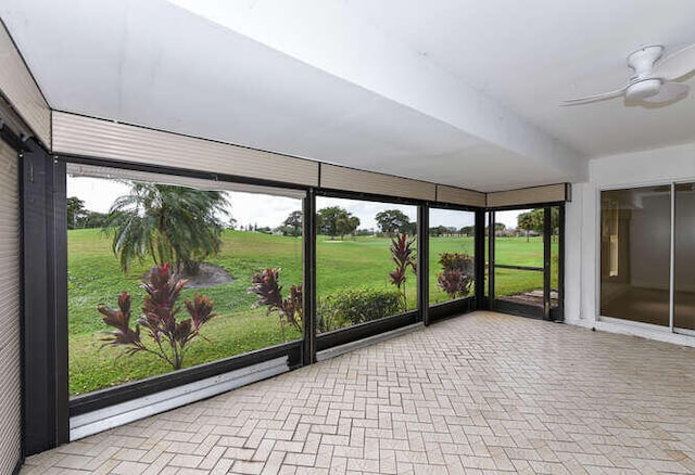 unfurnished sunroom featuring ceiling fan