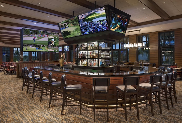 bar with carpet flooring, wood walls, and beam ceiling