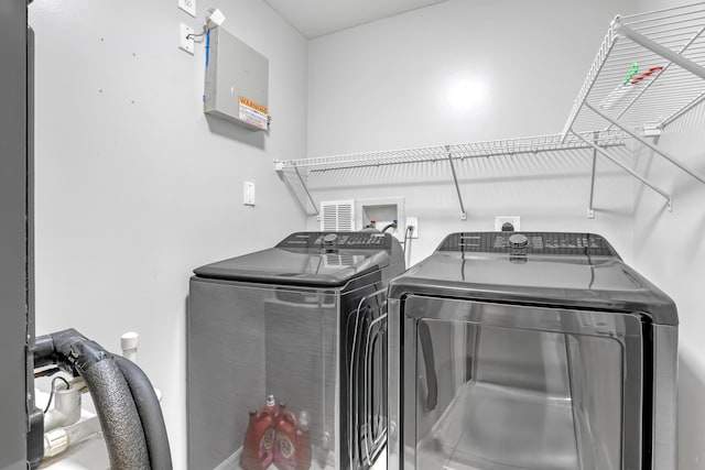 clothes washing area featuring independent washer and dryer