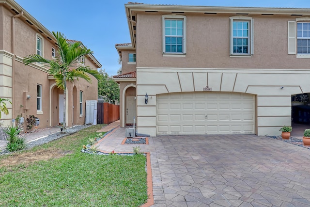 view of front of property featuring a garage and a front lawn