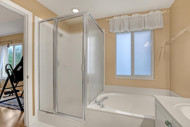 bathroom with vanity and separate shower and tub