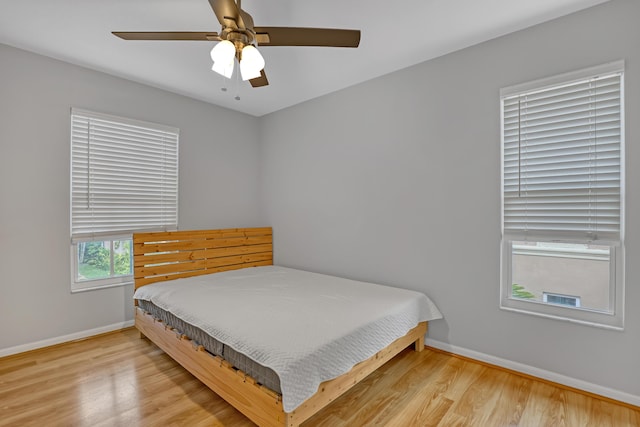 bedroom with light wood-type flooring and ceiling fan