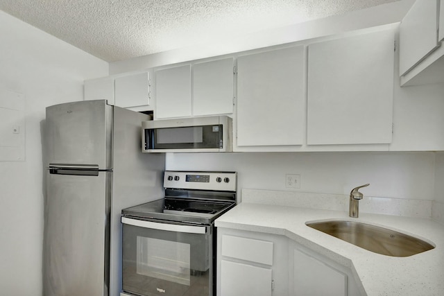 kitchen with white cabinetry, sink, and appliances with stainless steel finishes