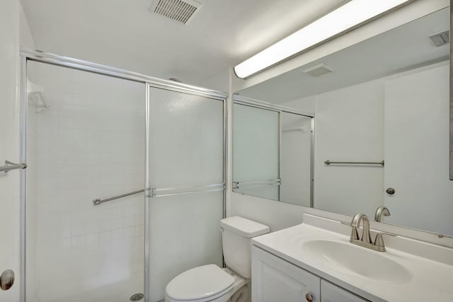 bathroom featuring vanity, an enclosed shower, and toilet