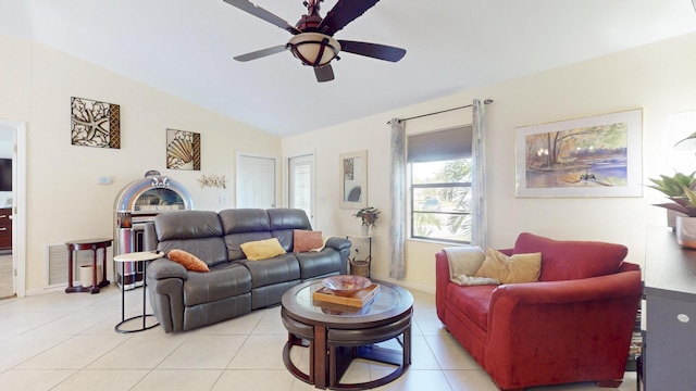 living room featuring ceiling fan, light tile patterned floors, and lofted ceiling