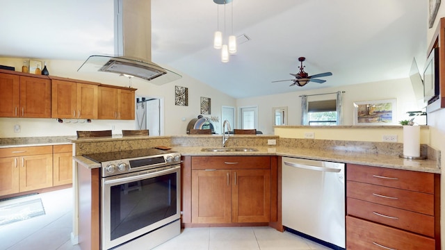 kitchen with island exhaust hood, appliances with stainless steel finishes, ceiling fan, sink, and decorative light fixtures