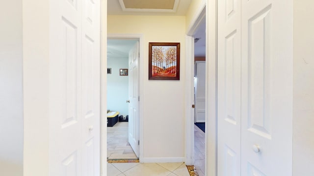 corridor with light tile patterned floors