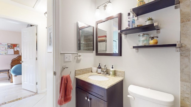 bathroom featuring tile patterned flooring, vanity, and toilet