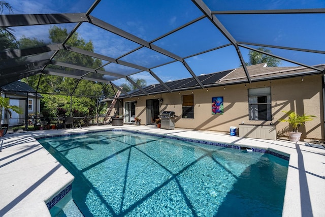 view of pool featuring a grill, a lanai, and a patio area