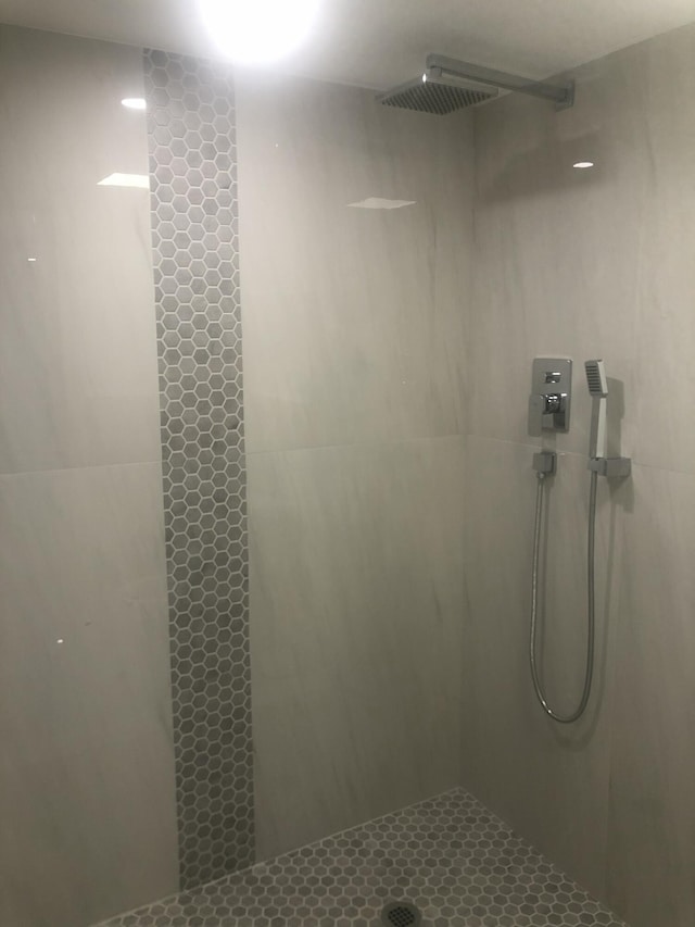 bathroom with a tile shower