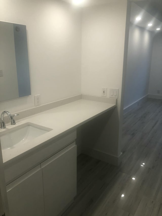 bathroom with hardwood / wood-style flooring and vanity