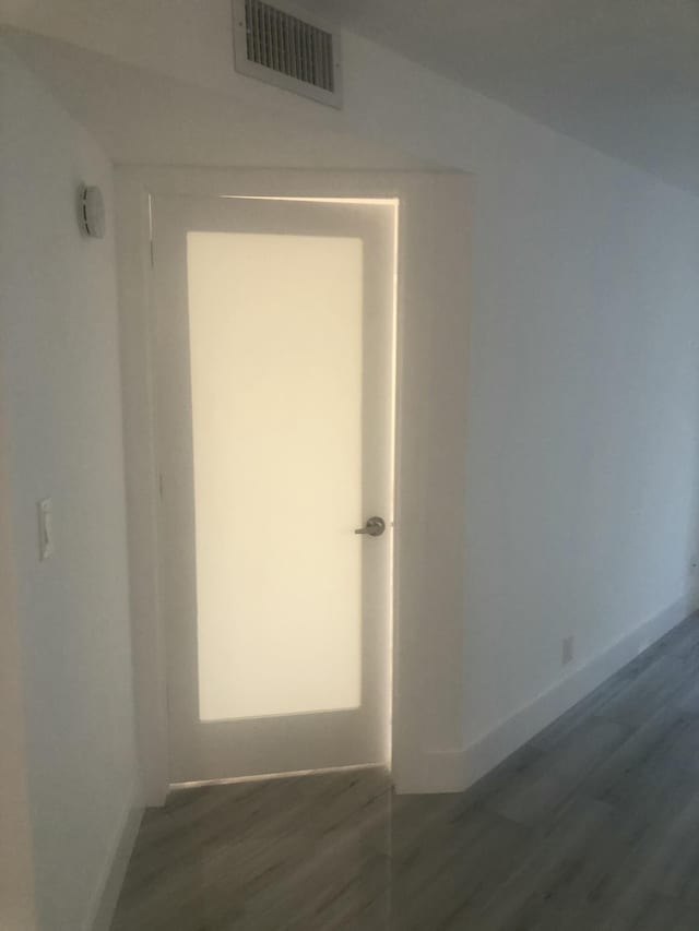 hallway with dark hardwood / wood-style flooring