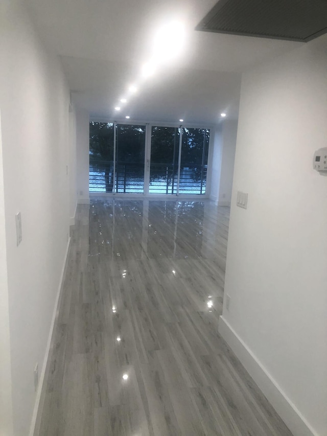 unfurnished room with hardwood / wood-style floors