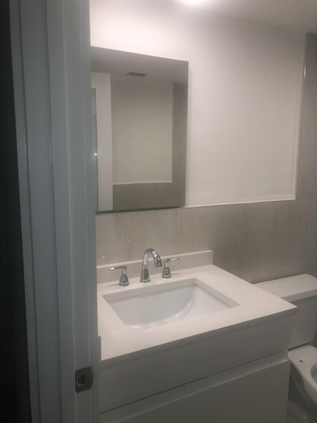 bathroom with vanity and toilet