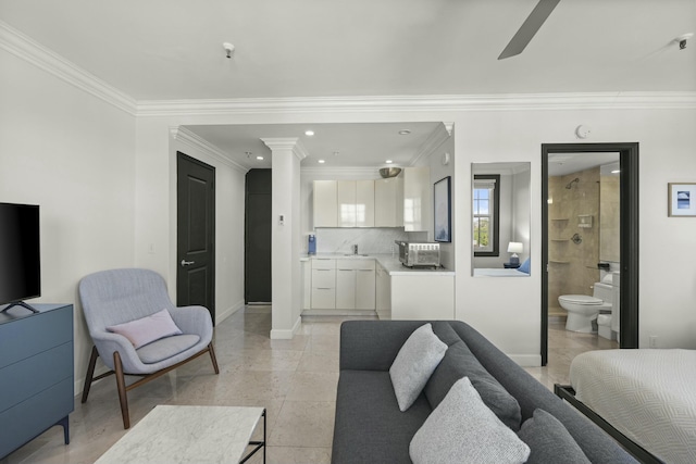 living room featuring ceiling fan, sink, and crown molding