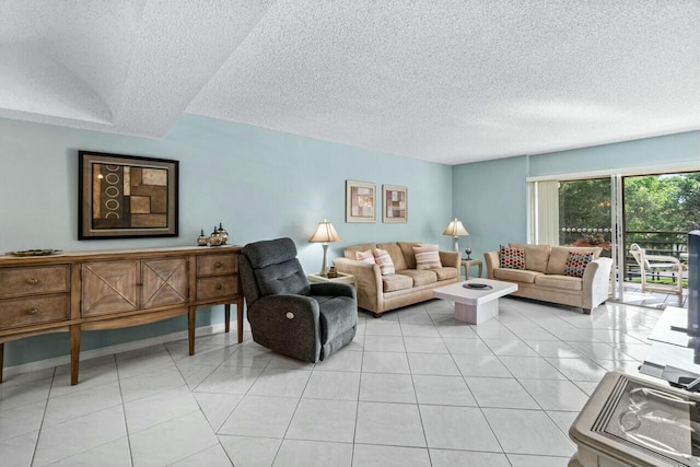 living room with a textured ceiling and light tile patterned floors