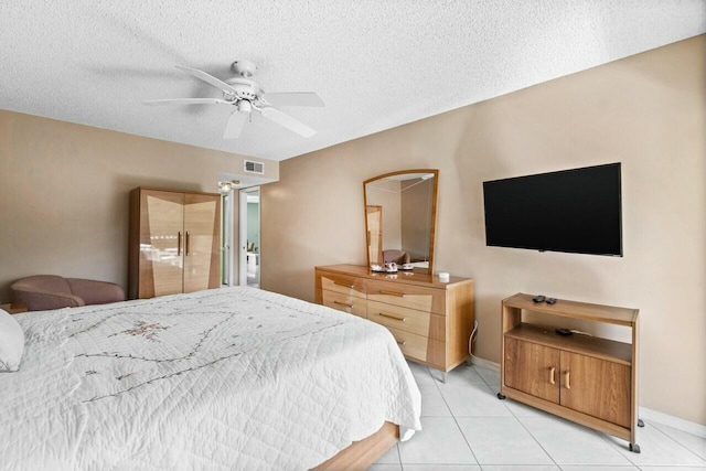 tiled bedroom featuring ceiling fan and a textured ceiling