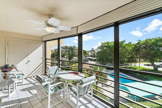 unfurnished sunroom with ceiling fan