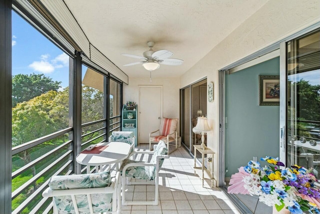 sunroom / solarium featuring ceiling fan