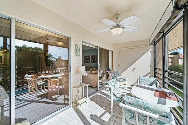 sunroom with a healthy amount of sunlight and ceiling fan