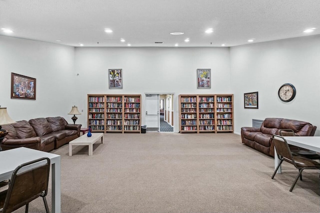 living room with a textured ceiling and light colored carpet