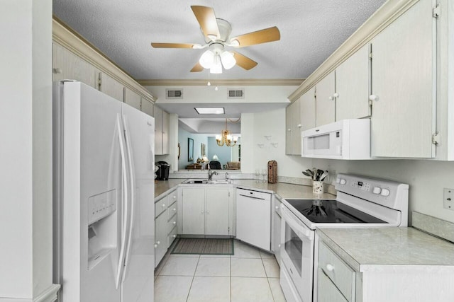 kitchen featuring sink, white appliances, a textured ceiling, and light tile patterned floors