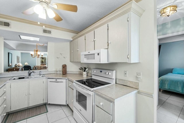 kitchen with white appliances, a textured ceiling, pendant lighting, light tile patterned floors, and sink