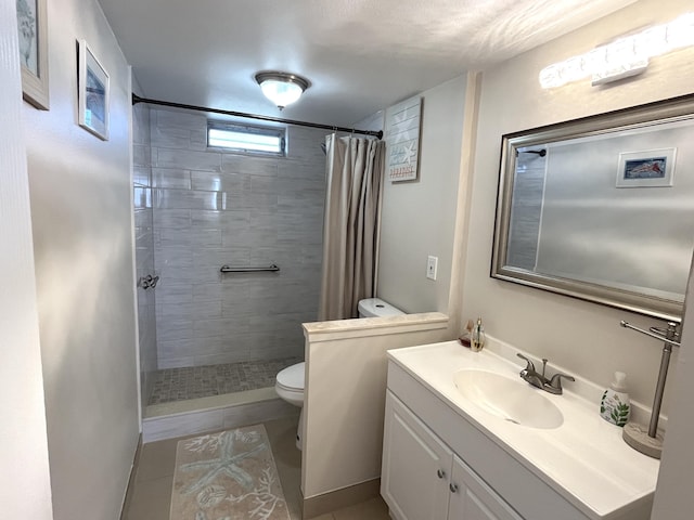 bathroom featuring tile patterned flooring, vanity, toilet, and walk in shower