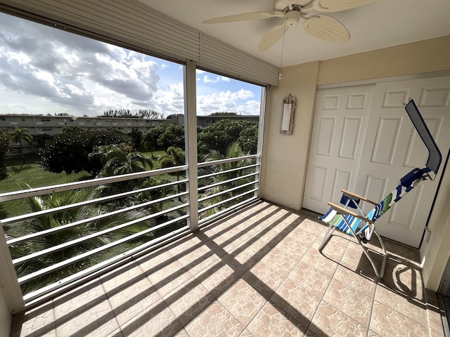 sunroom / solarium featuring ceiling fan