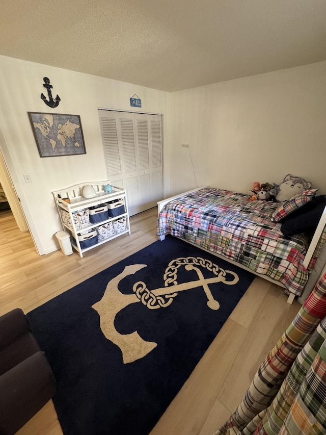 bedroom with a closet and hardwood / wood-style floors