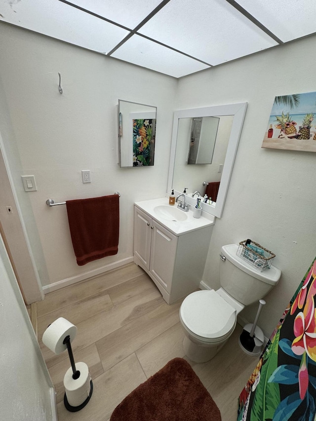 bathroom featuring hardwood / wood-style floors, vanity, and toilet