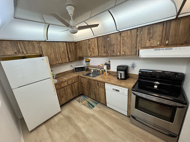 kitchen with white appliances, ventilation hood, sink, ceiling fan, and light wood-type flooring