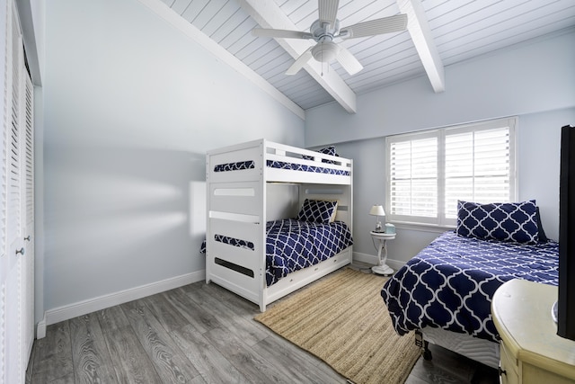 bedroom with wooden ceiling, vaulted ceiling with beams, ceiling fan, wood-type flooring, and a closet