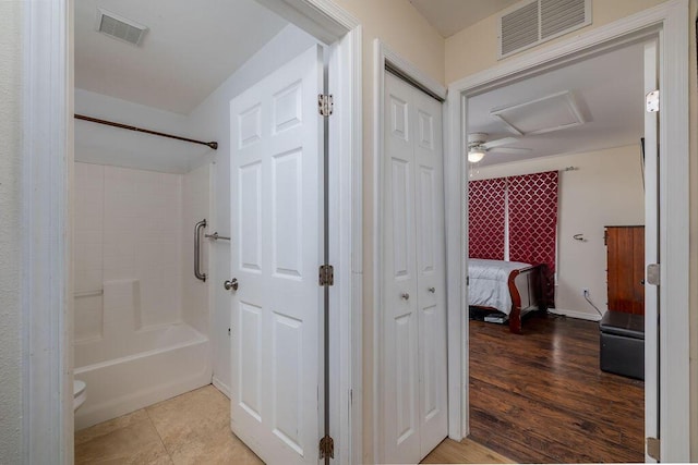 bathroom with tile patterned floors, shower / bathing tub combination, and toilet