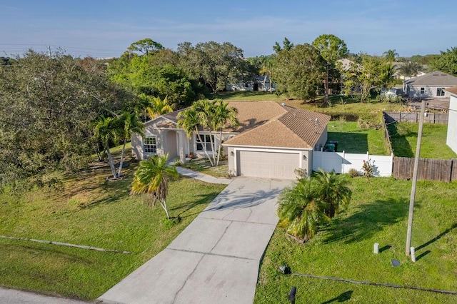 view of front of property featuring a garage and a front lawn