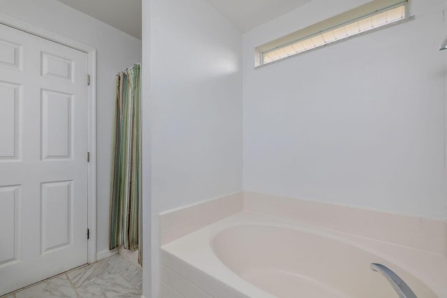 bathroom with tiled bath