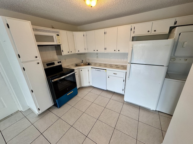 kitchen with white appliances, white cabinets, sink, a textured ceiling, and tasteful backsplash