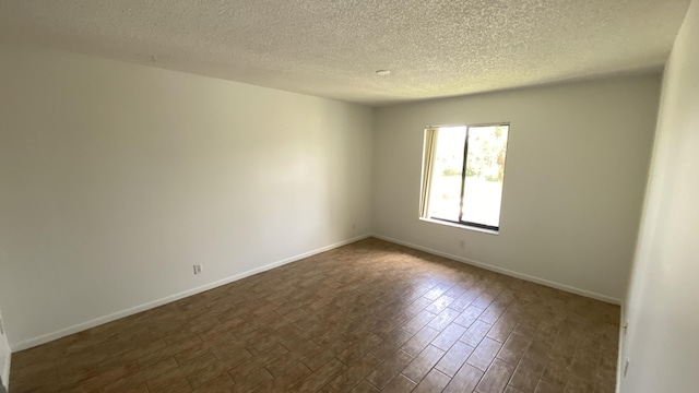 unfurnished room with a textured ceiling