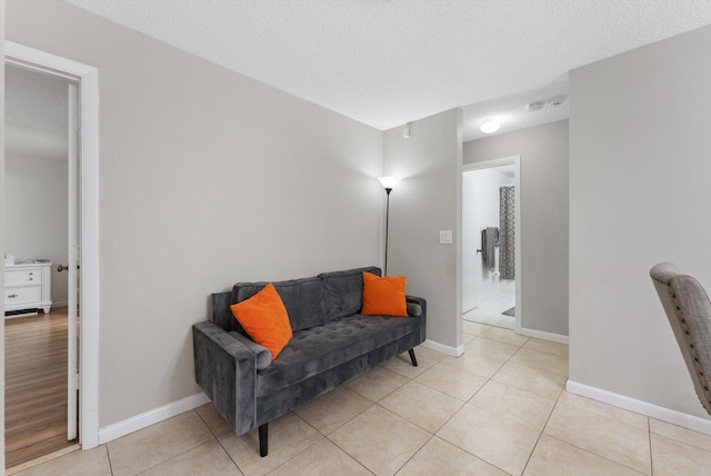 sitting room featuring light tile patterned floors and a textured ceiling