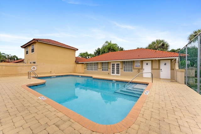 view of pool with a patio area and french doors