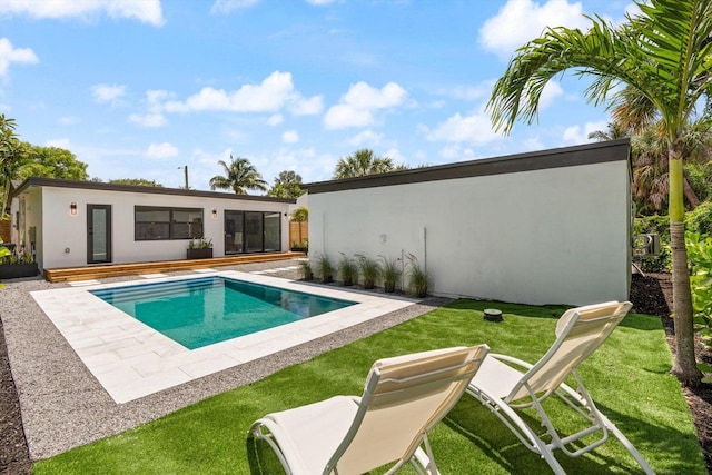 view of swimming pool with a lawn and a patio area