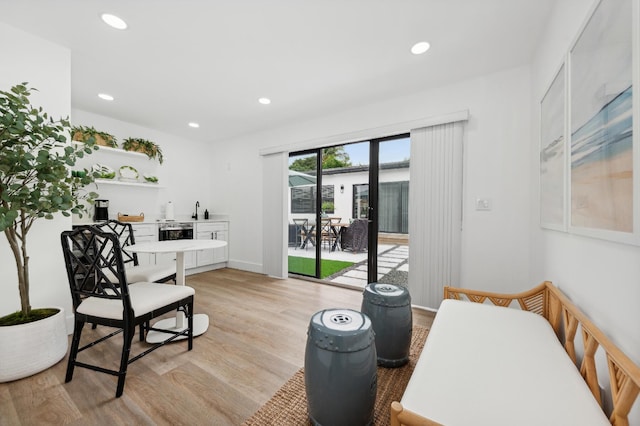 living area with light wood-type flooring and sink