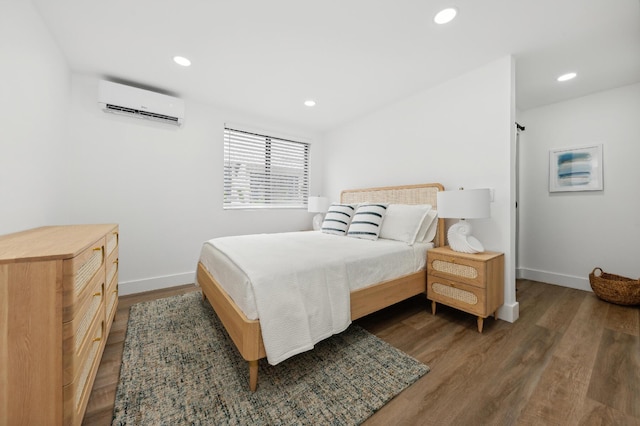 bedroom featuring dark wood-type flooring and a wall mounted AC