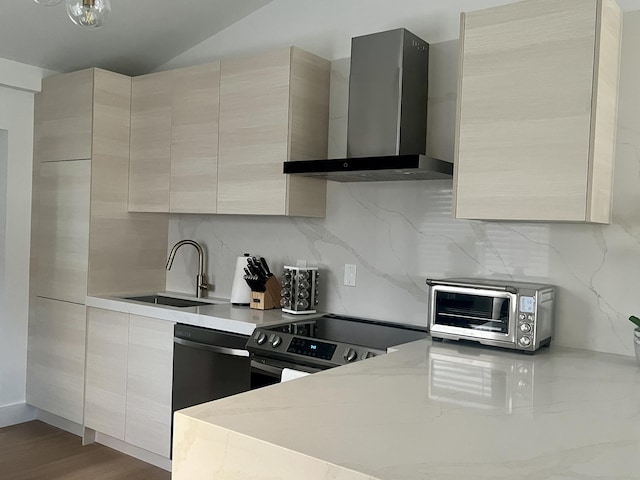 kitchen with stainless steel range with electric stovetop, backsplash, sink, wall chimney exhaust hood, and wood-type flooring