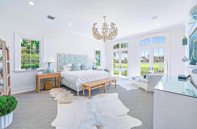 carpeted bedroom featuring crown molding, french doors, and an inviting chandelier