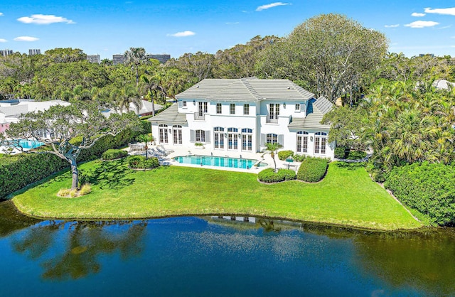 back of house featuring a yard and a water view