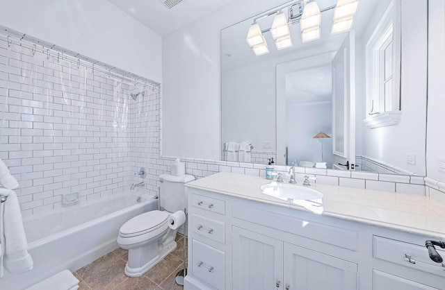 full bathroom featuring vanity, tiled shower / bath combo, tile walls, tile patterned flooring, and toilet