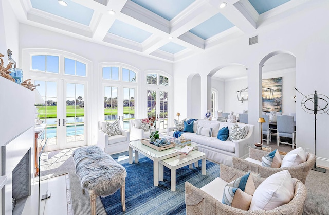 sunroom with beamed ceiling, french doors, and coffered ceiling