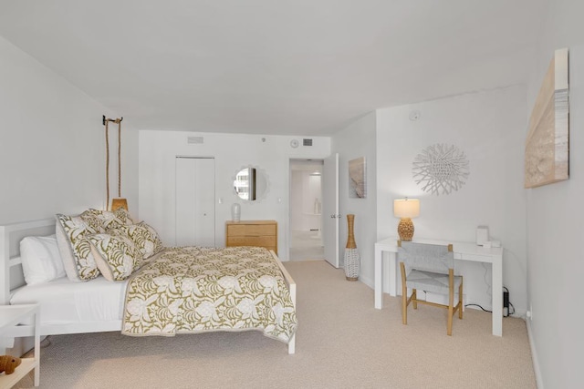 carpeted bedroom featuring connected bathroom